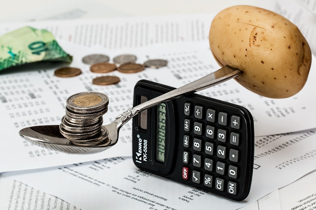 coins weighed against a potato